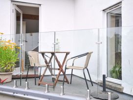 A balcony with a table and chairs at Little Hamlin in Rilla Mill Nr Callington
