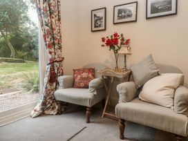 A snug with two armchairs and a small table at Banneth in Helford