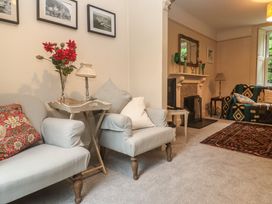 A living room with a sofa and table at Banneth in Helford