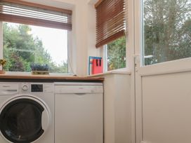 A utility room with a washing machine and a dishwasher at Banneth in Helford