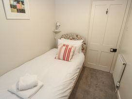 A bedroom with a bed and door at Banneth in Helford