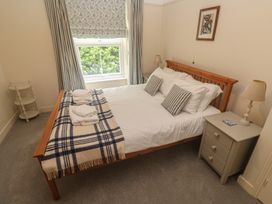 A bedroom with a bed and bedside lamp at Banneth in Helford