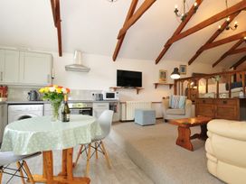 A living room with a table and chairs at Trevenning Chapel near Port Isaac