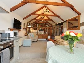 A living room with a sofa and television at Trevenning Chapel Near Port Isaac