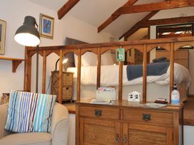 A bedroom with a bed and seating area at Trevenning Chapel Near Port Isaac