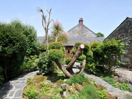 A garden with various plants and a tree at Trevenning Chapel Near Port Isaac