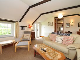 A living room with a couch and coffee table at Trevenning Barn near Port Isaac