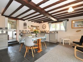 A kitchen with a dining table and chairs at Trevenning Barn Near Port Isaac