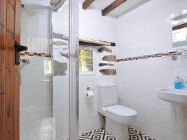 A bathroom with a shower and sink at Trevenning Barn Near Port Isaac