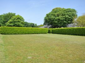 A garden with grass and hedges at Trevenning Barn Near Port Isaac