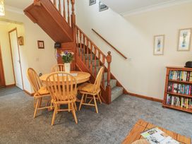 A dining room featuring a table and chairs at Two Hoots in Falmouth
