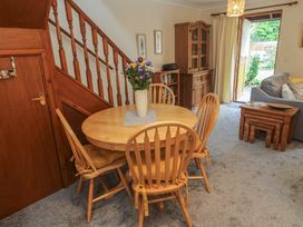 A dining room with a table and chairs at Two Hoots in Falmouth