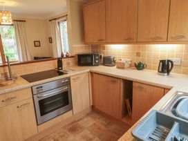 A kitchen with appliances on the counter at Two Hoots in Falmouth
