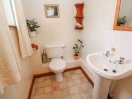A bathroom with a toilet and sink at Two Hoots in Falmouth