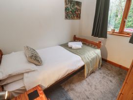 A bedroom with a single bed and artwork at Two Hoots in Falmouth