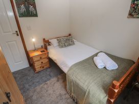 A bedroom with a single bed and bedside table at Two Hoots in Falmouth