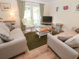A living room with a sofa and television at Sild Cottage in Falmouth