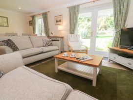 A living room with a sofa and coffee table at Sild Cottage in Falmouth