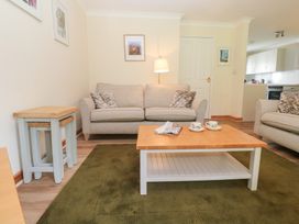 A living room with a sofa and coffee table at Sild Cottage in Falmouth