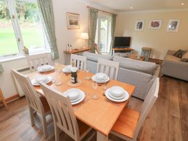 A dining area with a table set for dinner at Sild Cottage in Falmouth