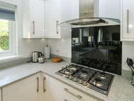 A kitchen with a stove and kettle at Glebe House in Bigbury