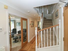 A hallway with a staircase and doors at Glebe House Bigbury