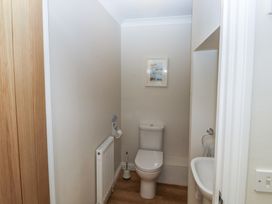 A bathroom with a toilet and wash basin at Glebe House Bigbury