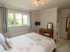 A bedroom with a bed and dresser at Glebe House in Bigbury