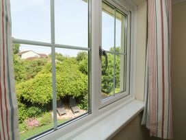 A window view of a garden with chairs at Glebe House Bigbury