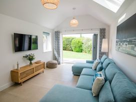 A living room with a sofa and television at Lanesend in St Agnes