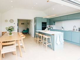 A kitchen with a dining area and modern fixtures at Lanesend in St Agnes