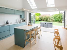 A kitchen with an island and stools at Lanesend in St Agnes