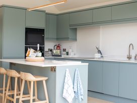 A kitchen with cabinets and appliances at Lanesend in St Agnes