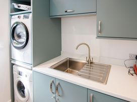 A laundry room with washing machine and dryer at Lanesend in St Agnes
