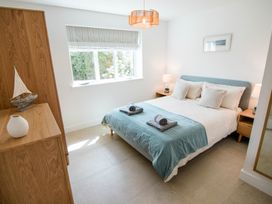 A bedroom with a bed and lamps at Lanesend in St Agnes