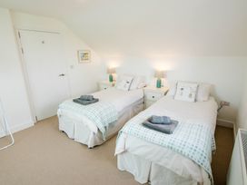 A bedroom with two single beds and a nightstand at Lanesend in St Agnes