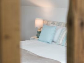 A bedroom with a bed and a lamp at Lanesend in St Agnes