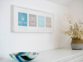 A decorative display with a picture frame and a vase at Lanesend in St Agnes