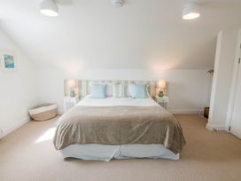 A bedroom with a bed and nightstands at Lanesend in St Agnes