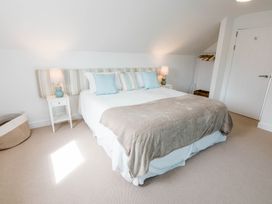 A bedroom with a bed and nightstand at Lanesend in St Agnes