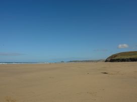 A beach with sand and hills at Lanesend in St Agnes