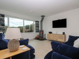 A living room with a fireplace and television at Lanesend in St Agnes