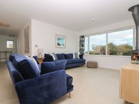 A living room with sofas and a fireplace at Lanesend in St Agnes