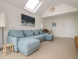 A living room with a sofa and a table at Lanesend in St Agnes