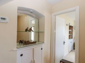 A hallway with a glass shelf and welcome sign at Blue Horizon in Brixham