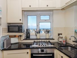 A kitchen with a window and cooking appliances at Blue Horizon in Brixham