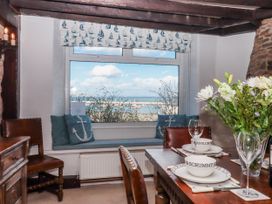 A dining room with a view of the sea at Blue Horizon in Brixham