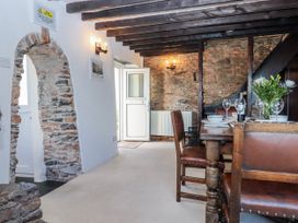 A dining room with a table and chairs at Blue Horizon in Brixham