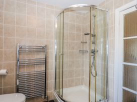 A bathroom with a shower and towel radiator at Blue Horizon in Brixham