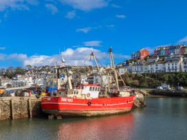 A fishing boat docked in a harbor at Blue Horizon in Brixham